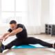 Athlete performing a seated forward bend after a workout