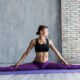 Individual doing Teaser exercise on a Pilates mat